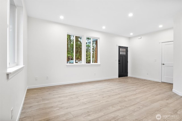 foyer with recessed lighting, light wood-style flooring, and baseboards