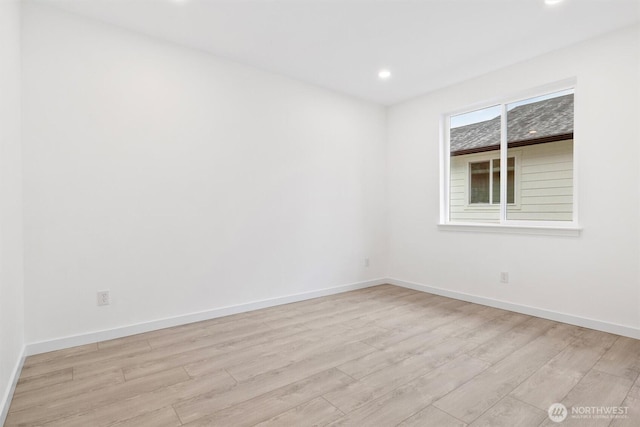 spare room with recessed lighting, baseboards, and light wood-style floors