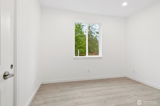 spare room featuring recessed lighting, light wood-type flooring, and baseboards