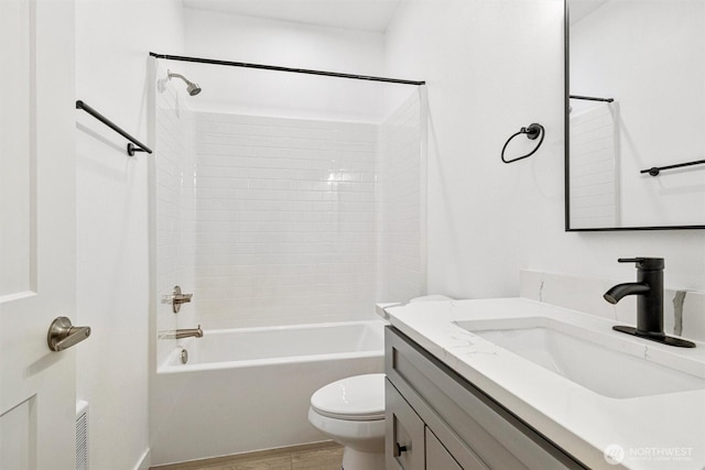 bathroom with wood finished floors, toilet, bathtub / shower combination, and vanity