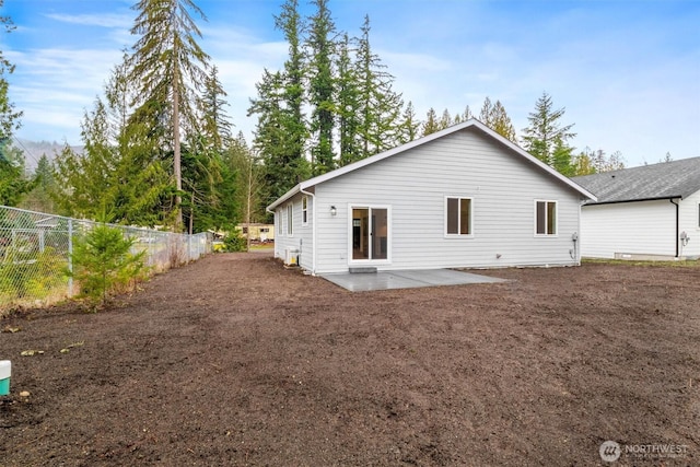 rear view of property with a patio area and fence