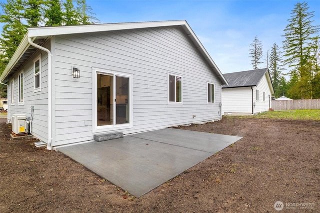 rear view of house featuring fence and a patio area