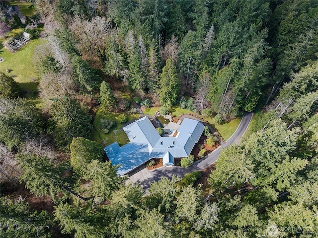 birds eye view of property with a wooded view