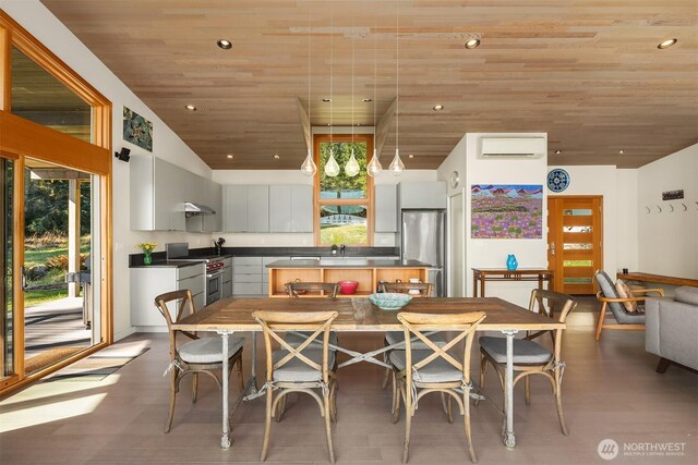 dining room featuring wood ceiling, lofted ceiling, a wall unit AC, recessed lighting, and wood finished floors