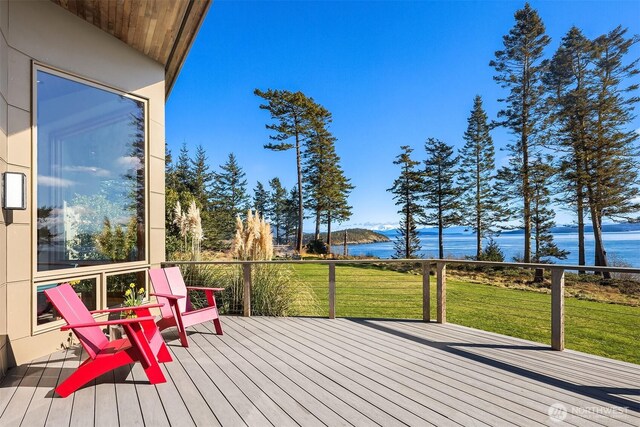 deck with a water view and a lawn