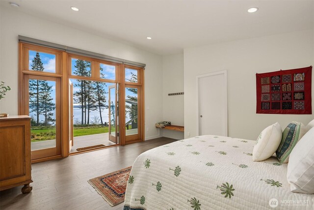 bedroom with recessed lighting, baseboards, wood finished floors, and access to outside