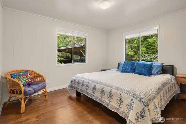 bedroom featuring baseboards and wood finished floors