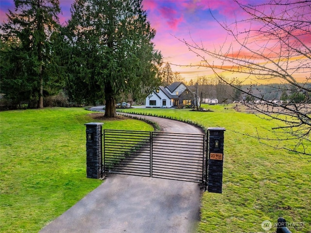 gate at dusk with a yard