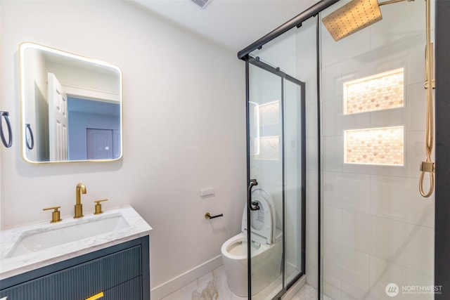 full bathroom with a stall shower, vanity, and baseboards