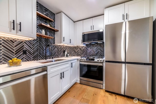 kitchen featuring white cabinets, stainless steel appliances, and open shelves