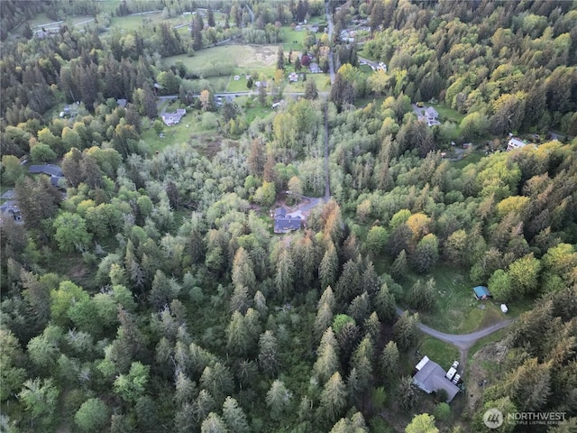 drone / aerial view featuring a forest view