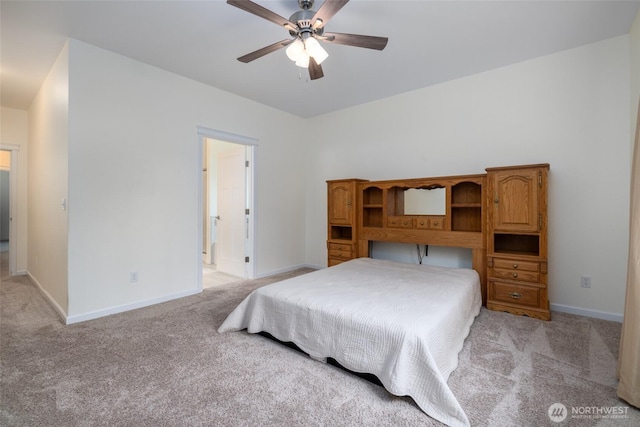 bedroom featuring light carpet, baseboards, connected bathroom, and a ceiling fan