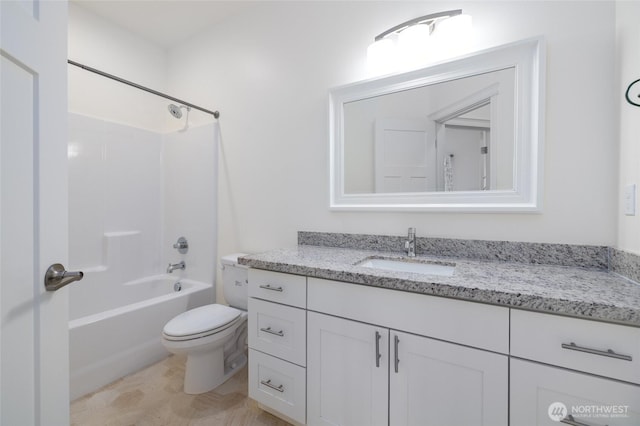 full bath featuring bathtub / shower combination, toilet, and vanity