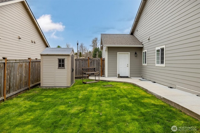 view of yard featuring an outdoor structure, a fenced backyard, a patio, and a storage shed