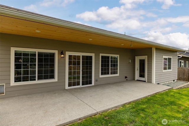 rear view of house featuring fence, a patio, and a yard