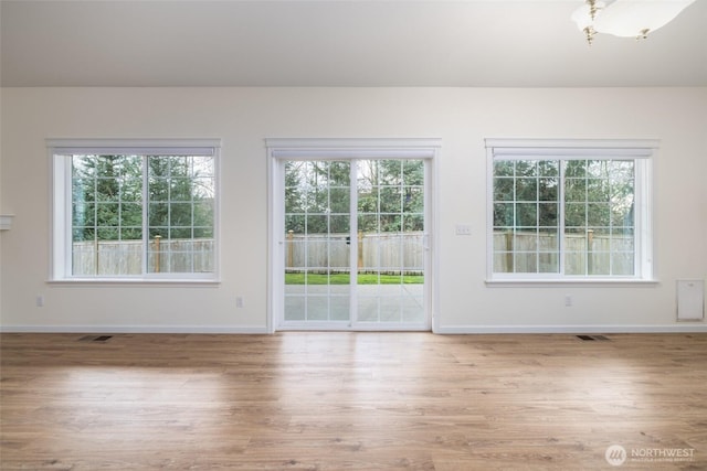 interior space with visible vents, wood finished floors, and a healthy amount of sunlight