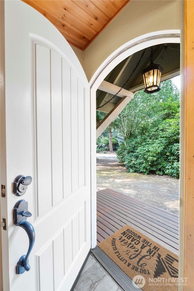 doorway to outside with wooden ceiling