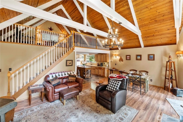 living area with stairway, an inviting chandelier, and light wood-style flooring