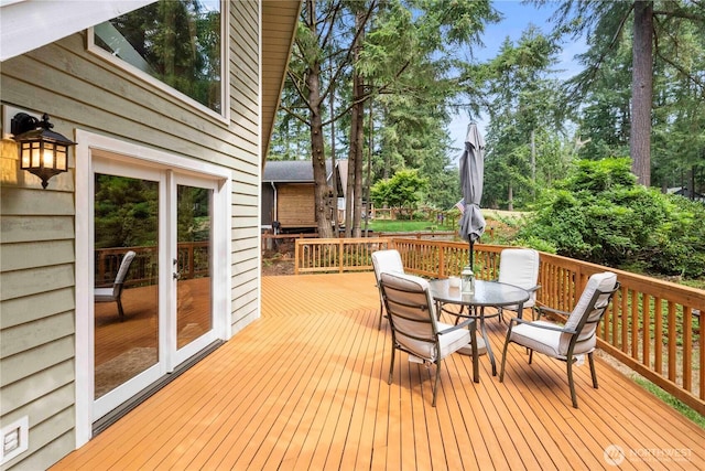 wooden deck featuring outdoor dining area