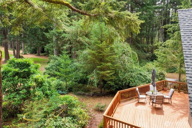 deck featuring a forest view