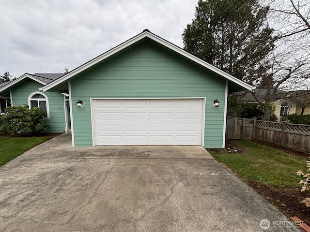 view of front of home featuring a garage and fence