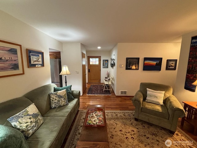 living room with visible vents and wood finished floors