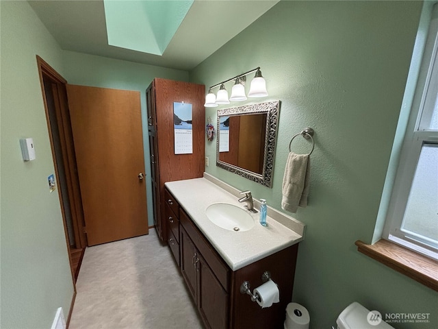 half bathroom with toilet and vanity