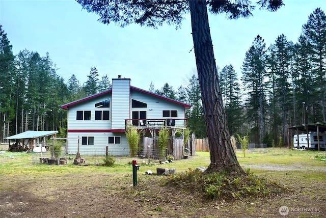 exterior space featuring a chimney and fence