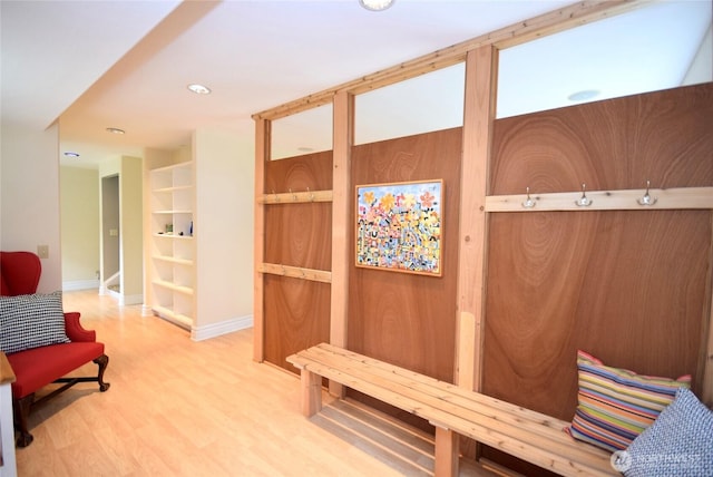 mudroom with wood finished floors and baseboards