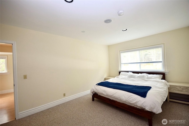 carpeted bedroom featuring recessed lighting, multiple windows, and baseboards