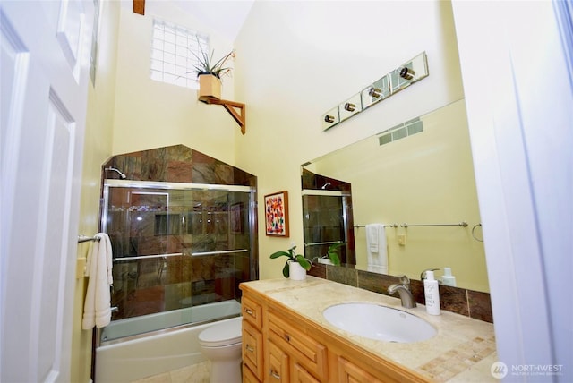 bathroom with vanity, toilet, visible vents, and bath / shower combo with glass door