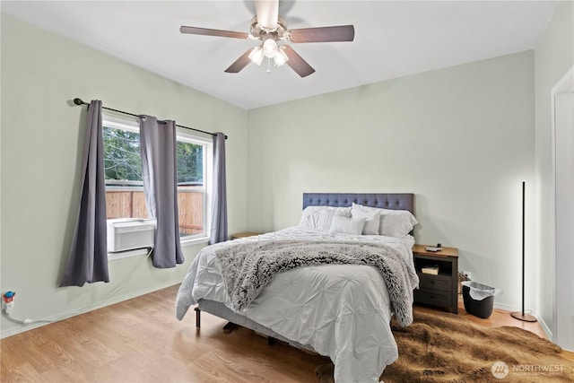 bedroom with wood finished floors and a ceiling fan
