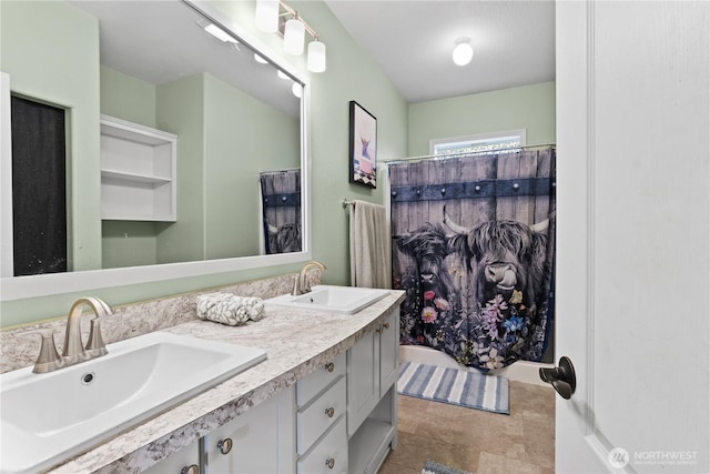 bathroom with a sink, a shower with curtain, and double vanity