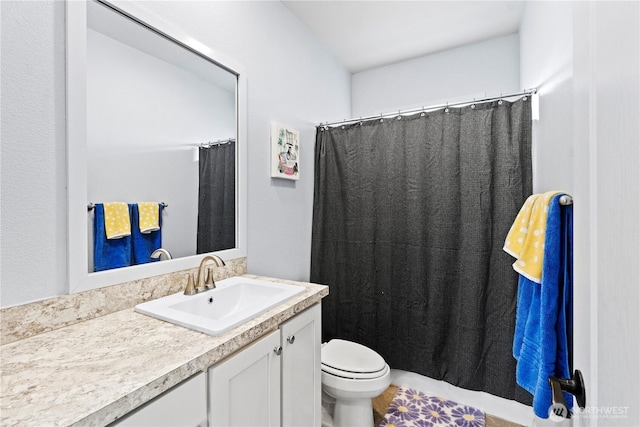 bathroom with vanity, curtained shower, and toilet