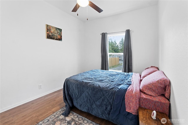 bedroom featuring a ceiling fan, wood finished floors, and baseboards