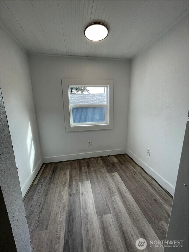 unfurnished room with wood finished floors and baseboards