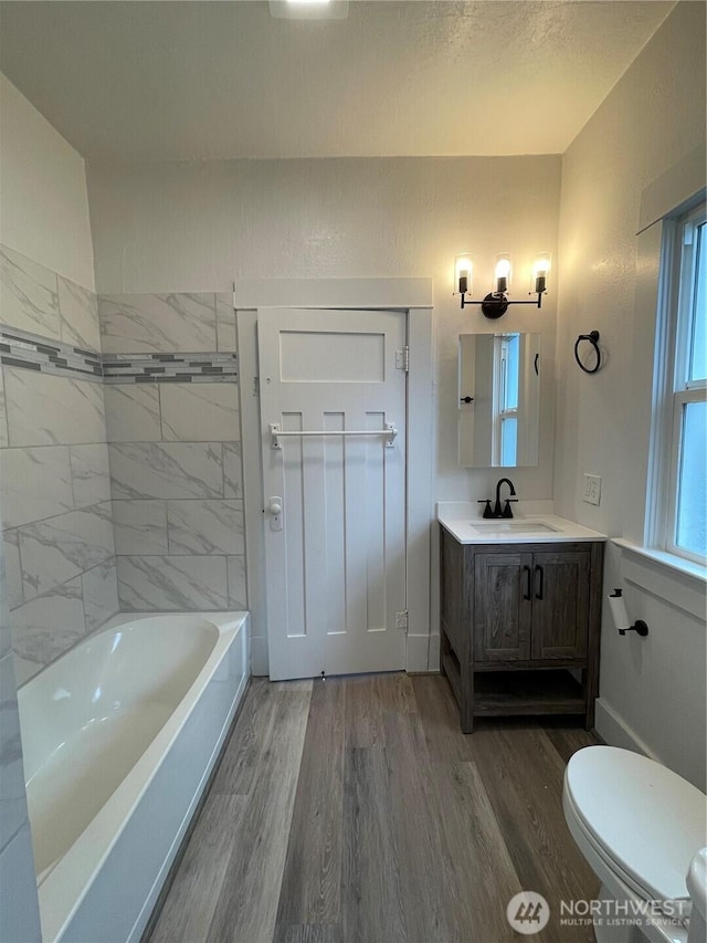 full bathroom with toilet, vanity, and wood finished floors