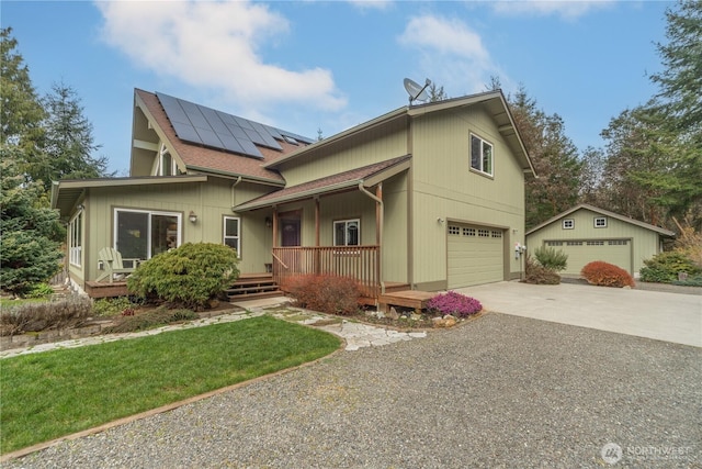 view of front of property featuring a porch, an attached garage, a shingled roof, concrete driveway, and roof mounted solar panels