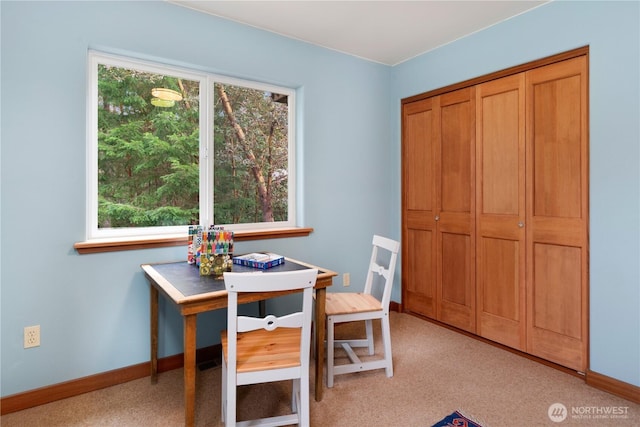 office with baseboards and light carpet