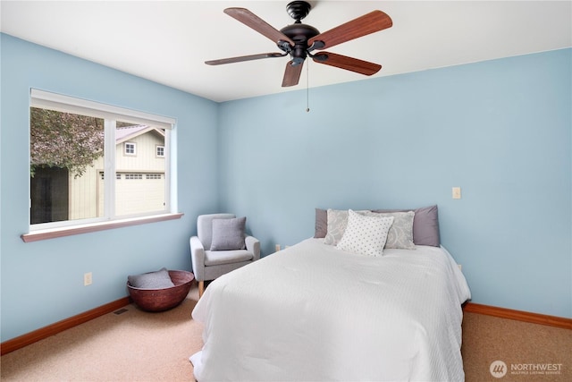 carpeted bedroom with baseboards and ceiling fan