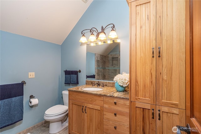 bathroom with vanity, lofted ceiling, and toilet