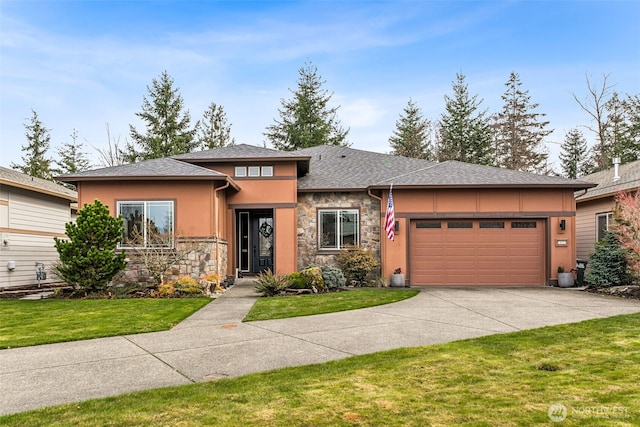 prairie-style house with driveway, stone siding, stucco siding, a front lawn, and a garage