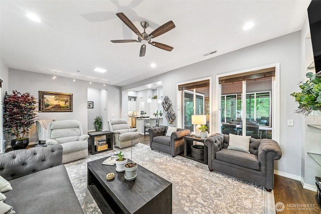 living room with visible vents, baseboards, recessed lighting, wood finished floors, and a ceiling fan