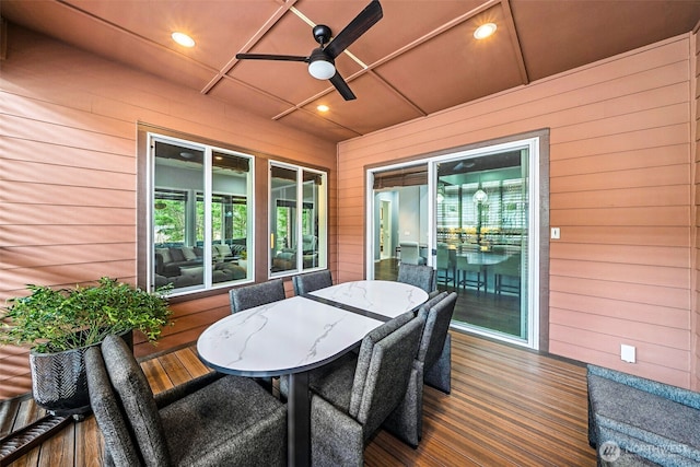 wooden deck with a ceiling fan and outdoor dining area