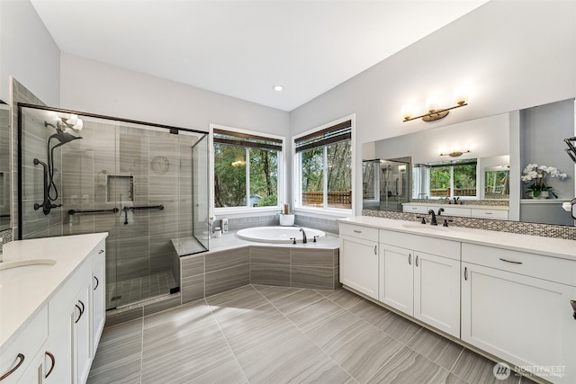 full bathroom featuring tile patterned floors, two vanities, a shower stall, and a sink