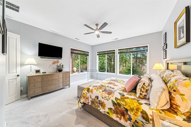 carpeted bedroom with visible vents and ceiling fan