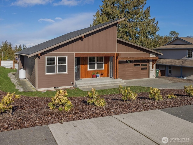 view of front of house with driveway, covered porch, and an attached garage