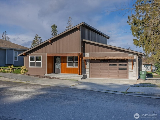 view of front facade with an attached garage, board and batten siding, and driveway