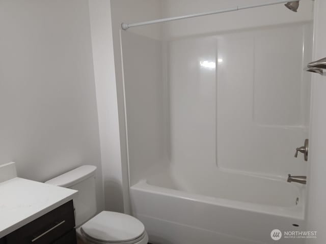 bathroom with bathing tub / shower combination, toilet, and vanity