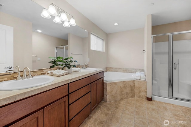 full bathroom featuring a shower stall, a bath, double vanity, and a sink